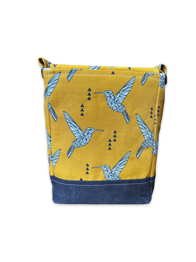Back of small yellow purse with black base
