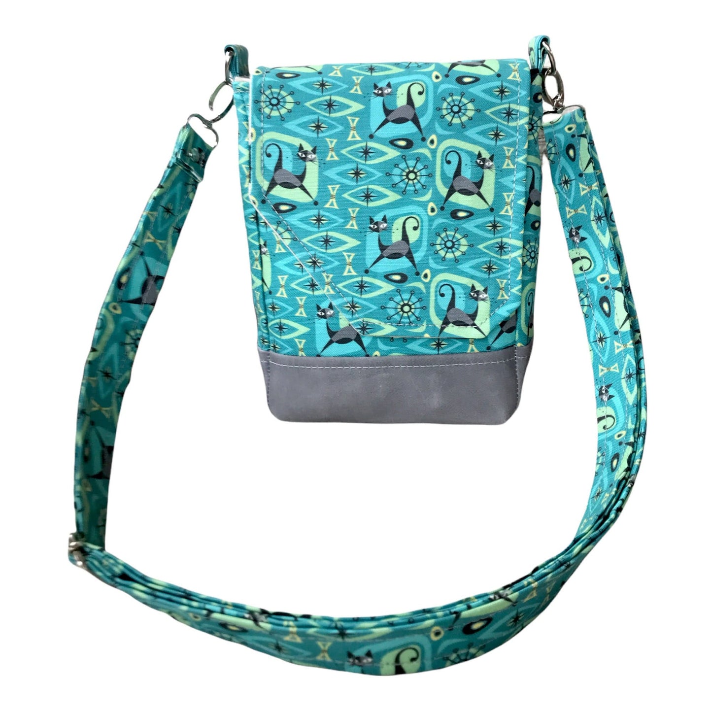 Cat print purse featuring midcentury atomic design with magnetic closure, two pockets, and a main compartment. Bag size is 8.5" x 6" x 3".